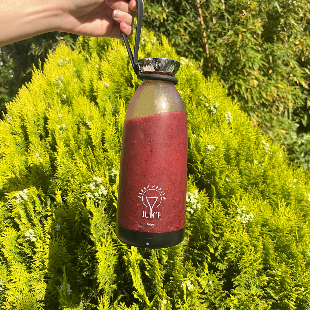 The base of a white Fresh Juice Blender Max upside down, which is put under water for washing.